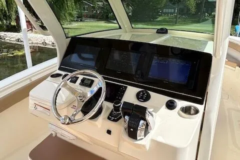 Seas Today Yacht Photos Pics 2019 Scout 355 LXF boat dashboard with steering wheel and navigation screens.