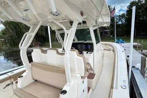 Seas Today Yacht Photos Pics 2019 Scout 355 LXF boat interior with seating and helm, docked by a lake.