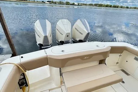 Seas Today Yacht Photos Pics 2019 Scout 355 LXF boat with triple Mercury outboard engines on a calm lake.