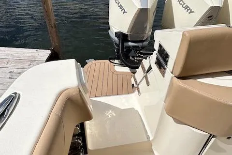 Seas Today Yacht Photos Pics 2019 Scout 355 LXF boat with Mercury engines, docked by the water.