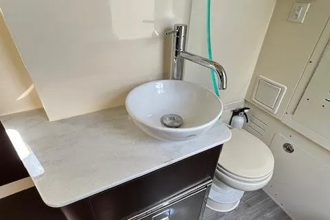 Seas Today Yacht Photos Pics 2019 Scout 355 LXF boat bathroom with modern sink and toilet.