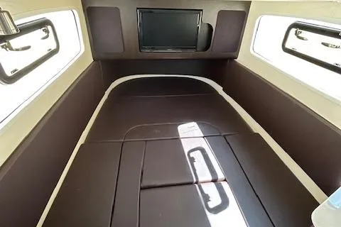 Seas Today Yacht Photos Pics 2019 Scout 355 LXF cabin interior with brown cushioned seating and windows.