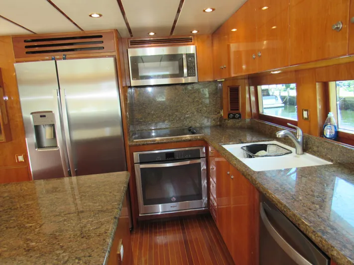 Sanctuary Yacht Photos Pics Luxurious kitchen in 2002 Hargrave Raised Pilothouse yacht with granite countertops and stainless steel appliances.