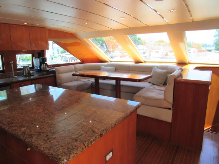 Sanctuary Yacht Photos Pics Luxurious 2002 Hargrave Raised Pilothouse yacht interior with granite countertop and plush seating area.