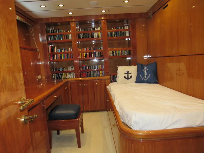Sanctuary Yacht Photos Pics Luxurious 2002 Hargrave Raised Pilothouse yacht cabin with wood paneling and built-in bookshelves.