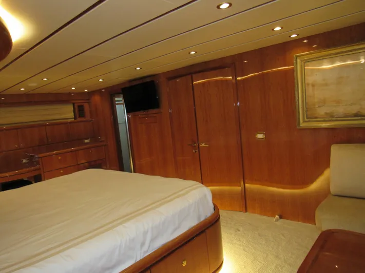 Sanctuary Yacht Photos Pics Luxurious 2002 Hargrave Raised Pilothouse yacht bedroom with wood paneling and elegant decor.