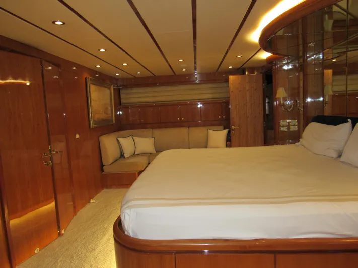 Sanctuary Yacht Photos Pics Luxurious bedroom interior of 2002 Hargrave Raised Pilothouse yacht with wood paneling.
