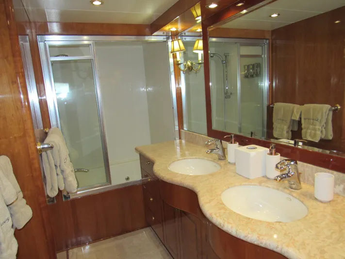 Sanctuary Yacht Photos Pics Luxurious bathroom in 2002 Hargrave Raised Pilothouse yacht with dual sinks and elegant wood finishes.
