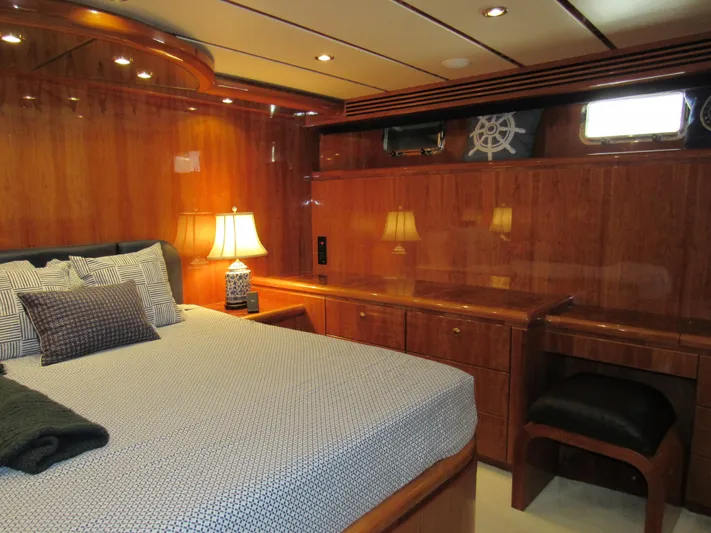 Sanctuary Yacht Photos Pics Luxurious bedroom in 2002 Hargrave Raised Pilothouse yacht with elegant wood paneling and ambient lighting.
