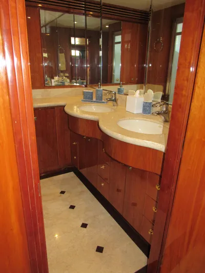 Sanctuary Yacht Photos Pics Luxurious bathroom in 2002 Hargrave Raised Pilothouse yacht with dual sinks and elegant wood cabinetry.