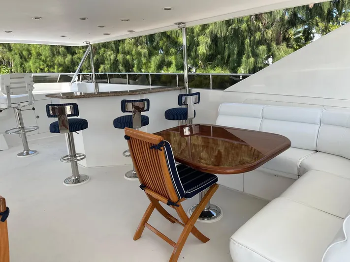 Sanctuary Yacht Photos Pics Luxurious 2002 Hargrave Raised Pilothouse yacht deck with seating and bar stools.
