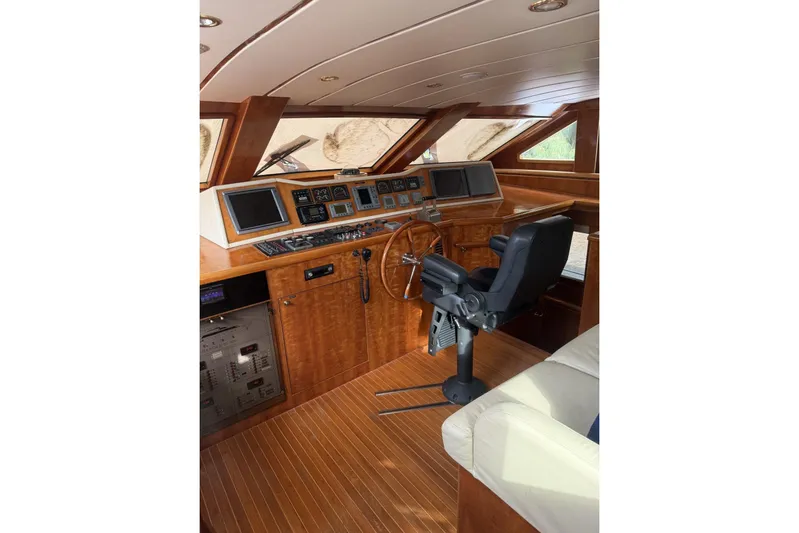 Sanctuary Yacht Photos Pics Luxurious 2002 Hargrave Raised Pilothouse interior with wood finish and modern navigation equipment.