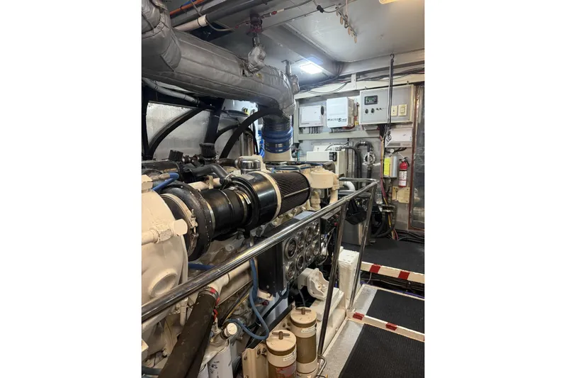 Sanctuary Yacht Photos Pics Engine room of 2002 Hargrave Raised Pilothouse yacht, showcasing machinery and control panels.