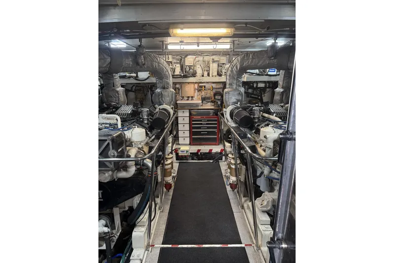 Sanctuary Yacht Photos Pics Engine room of a 2002 Hargrave Raised Pilothouse yacht, featuring organized machinery and tools.