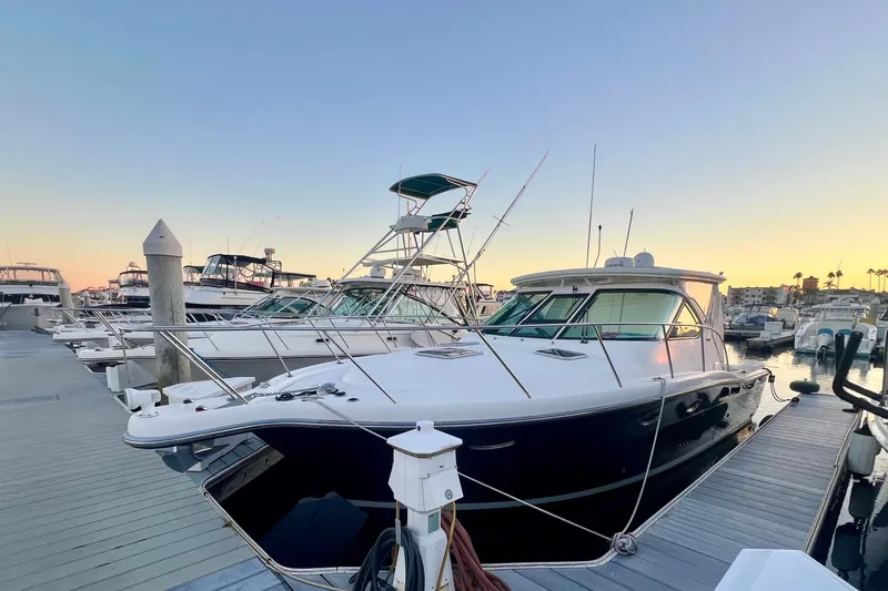 Blue Pearl Yacht Photos Pics 2005 Tiara Yachts 3200 Open docked at sunset, showcasing sleek design and luxury features.