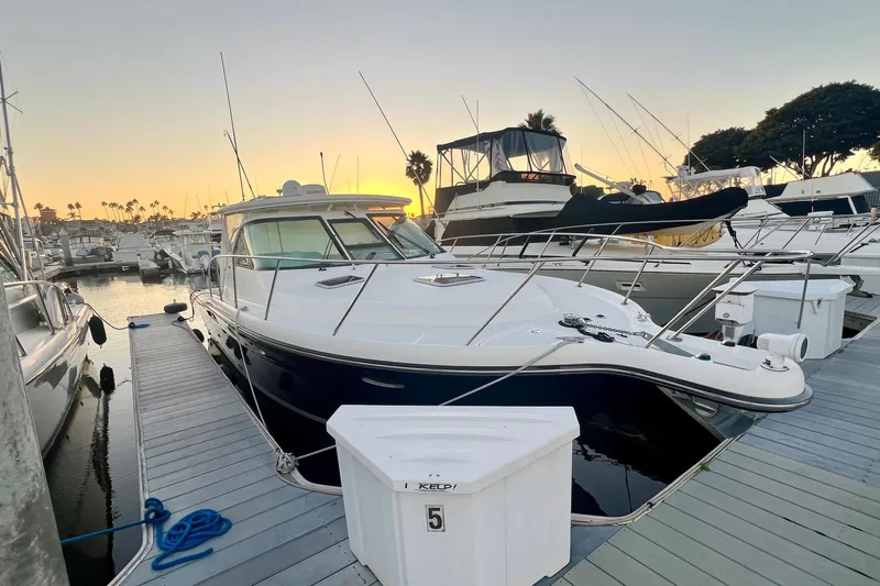 Blue Pearl Yacht Photos Pics 2005 Tiara Yachts 3200 Open docked at sunset, surrounded by other boats.