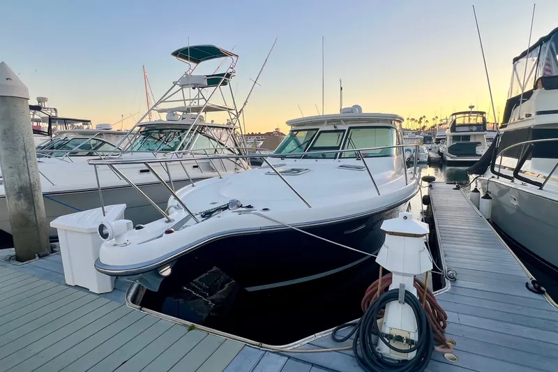 Blue Pearl Yacht Photos Pics 2005 Tiara Yachts 3200 Open docked at marina during sunset.