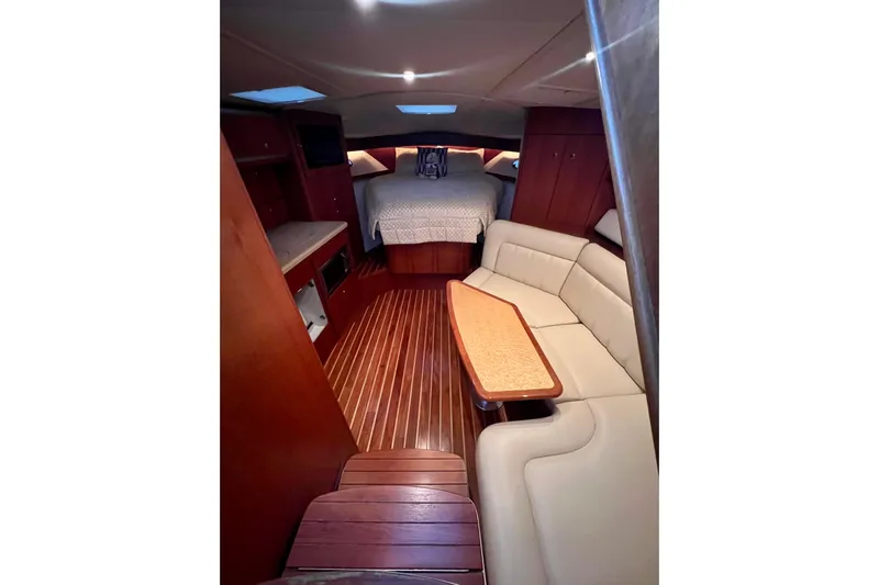 Blue Pearl Yacht Photos Pics Luxurious interior of 2005 Tiara Yachts 3200 Open with elegant wood finishes and cozy seating.