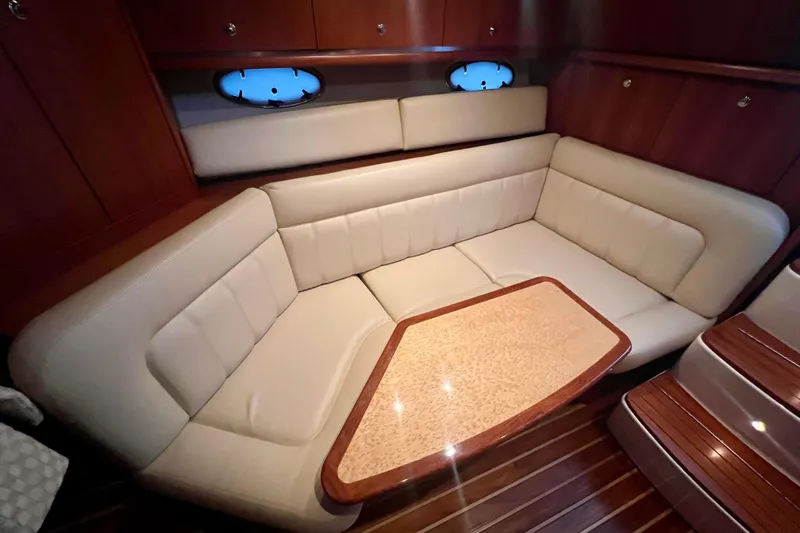 Blue Pearl Yacht Photos Pics Luxurious interior of 2005 Tiara Yachts 3200 Open with plush seating and wooden accents.