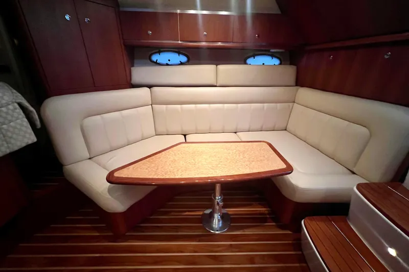 Blue Pearl Yacht Photos Pics Luxurious interior of 2005 Tiara Yachts 3200 Open with elegant seating and wooden table.