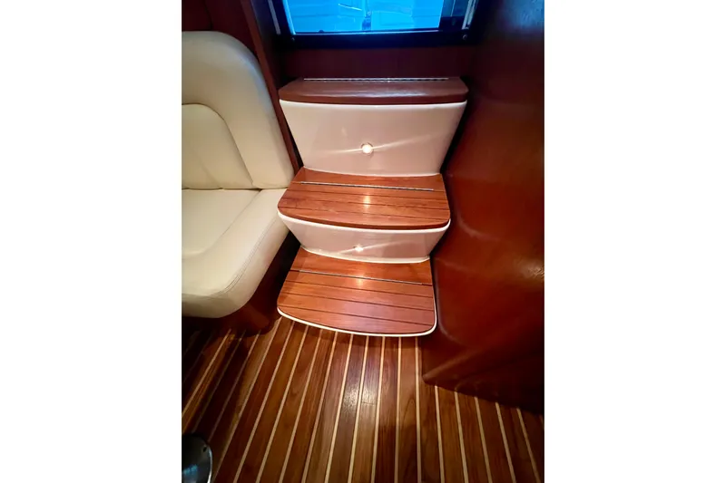 Blue Pearl Yacht Photos Pics Interior of 2005 Tiara Yachts 3200 Open, featuring wooden steps and seating.