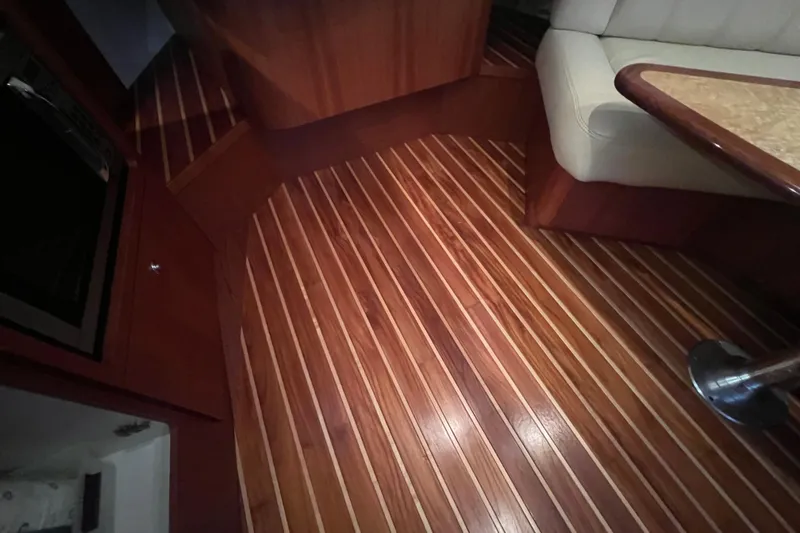 Blue Pearl Yacht Photos Pics Luxurious wood interior of 2005 Tiara Yachts 3200 Open, featuring elegant flooring and seating.