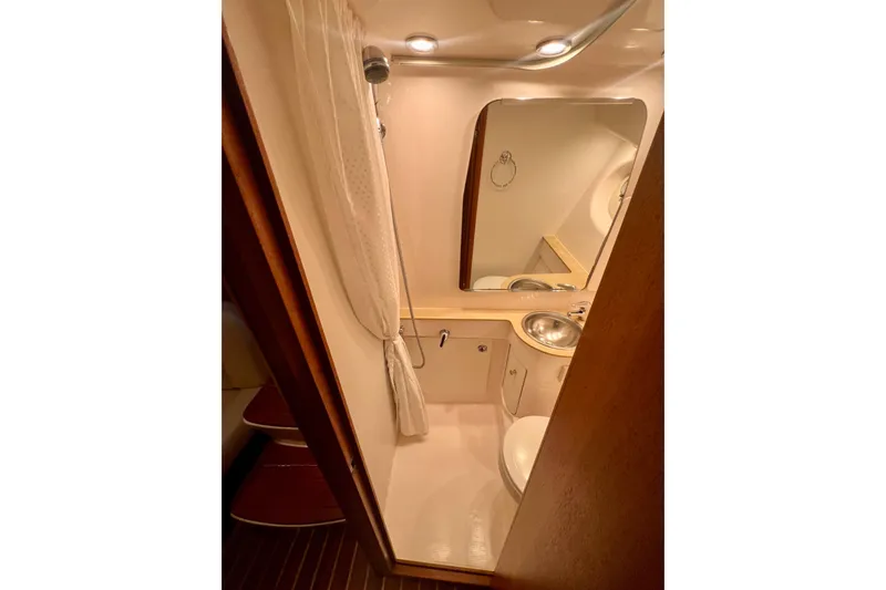 Blue Pearl Yacht Photos Pics 2005 Tiara Yachts 3200 Open bathroom with sink, mirror, and shower curtain.