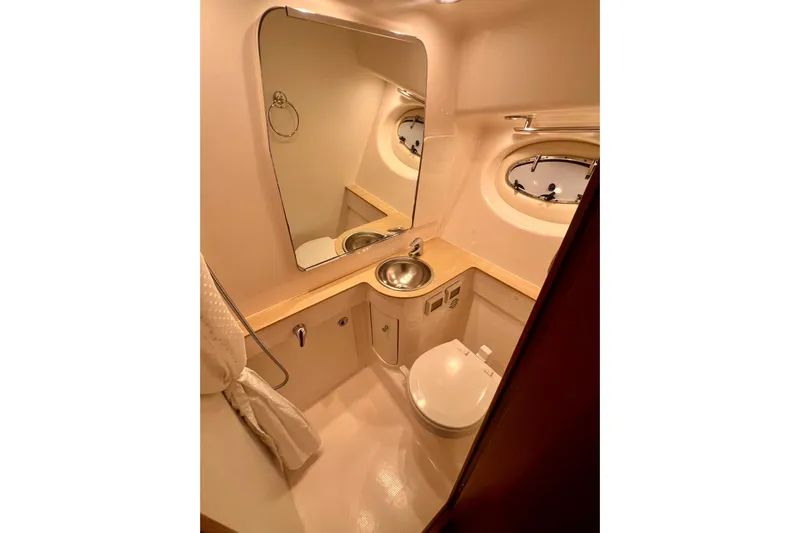 Blue Pearl Yacht Photos Pics Luxurious 2005 Tiara Yachts 3200 Open bathroom with mirror, sink, and porthole window.