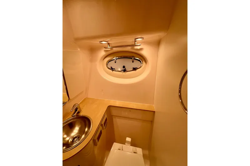 Blue Pearl Yacht Photos Pics 2005 Tiara Yachts 3200 Open bathroom with stainless steel sink and porthole window.