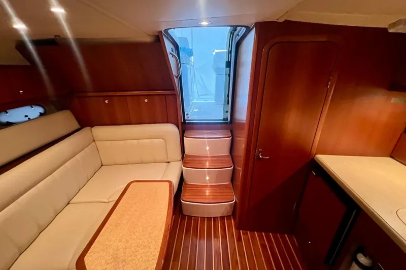 Blue Pearl Yacht Photos Pics 2005 Tiara Yachts 3200 Open interior with wood finish, beige seating, and steps to deck.