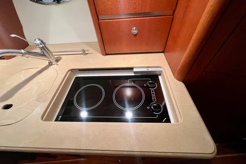 Blue Pearl Yacht Photos Pics 2005 Tiara Yachts 3200 Open kitchen with sleek stovetop and modern faucet.