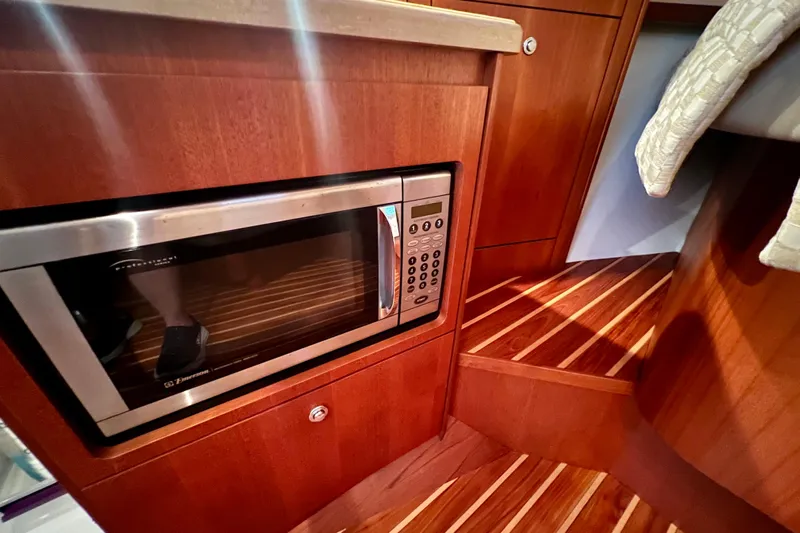 Blue Pearl Yacht Photos Pics 2005 Tiara Yachts 3200 Open interior with microwave and wooden flooring.