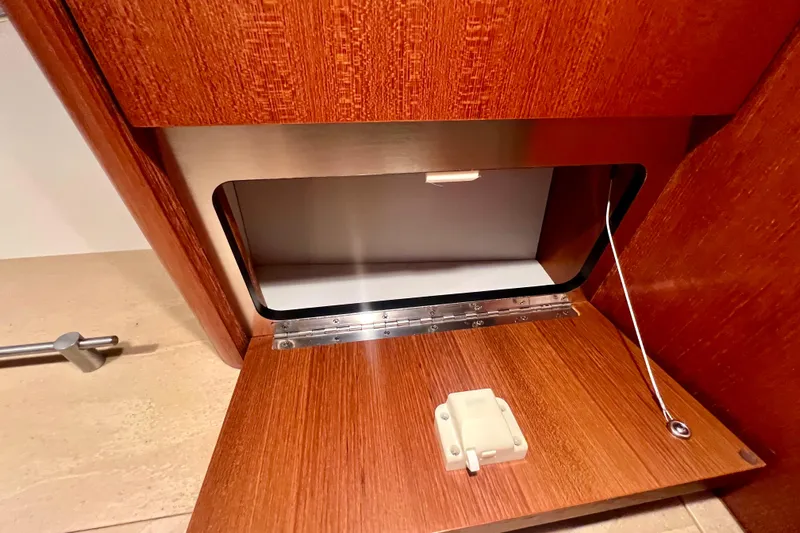 Blue Pearl Yacht Photos Pics 2005 Tiara Yachts 3200 Open interior storage compartment with wooden finish.