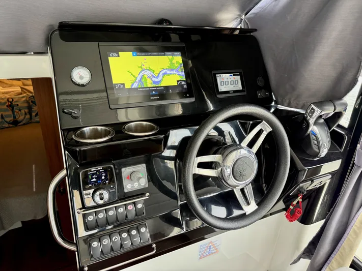 Remotely Workin' Yacht Photos Pics 2022 Jeanneau NC 1095 Coupe helm with navigation display and controls.