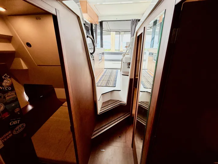 Remotely Workin' Yacht Photos Pics Interior view of 2022 Jeanneau NC 1095 Coupe boat, featuring modern design and wood finishes.