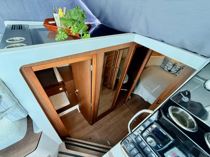 Remotely Workin' Yacht Photos Pics Interior view of 2022 Jeanneau NC 1095 Coupe, featuring wood finishes and modern design.