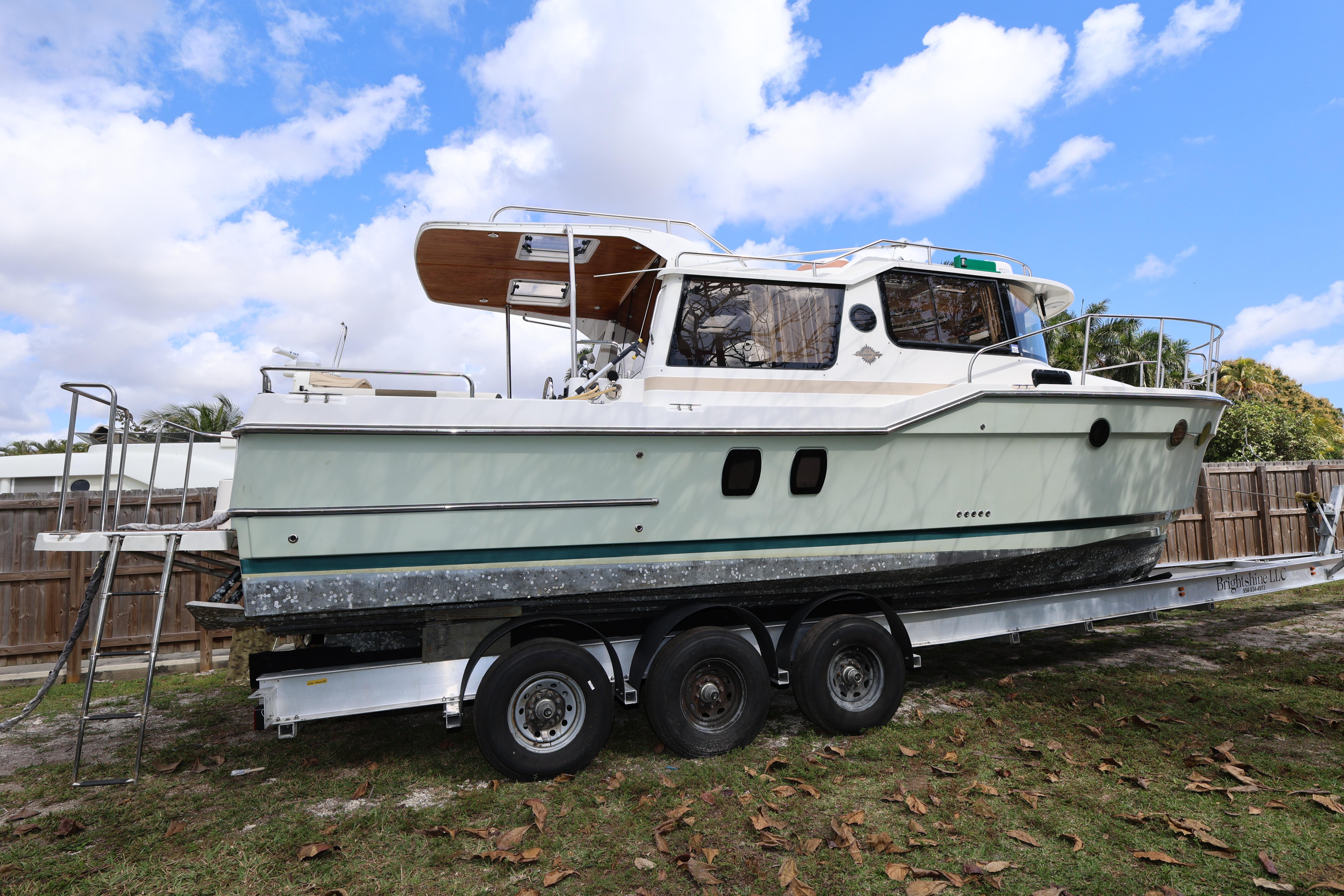 2015 Ranger Tugs R-29 S boat on trailer under blue sky.