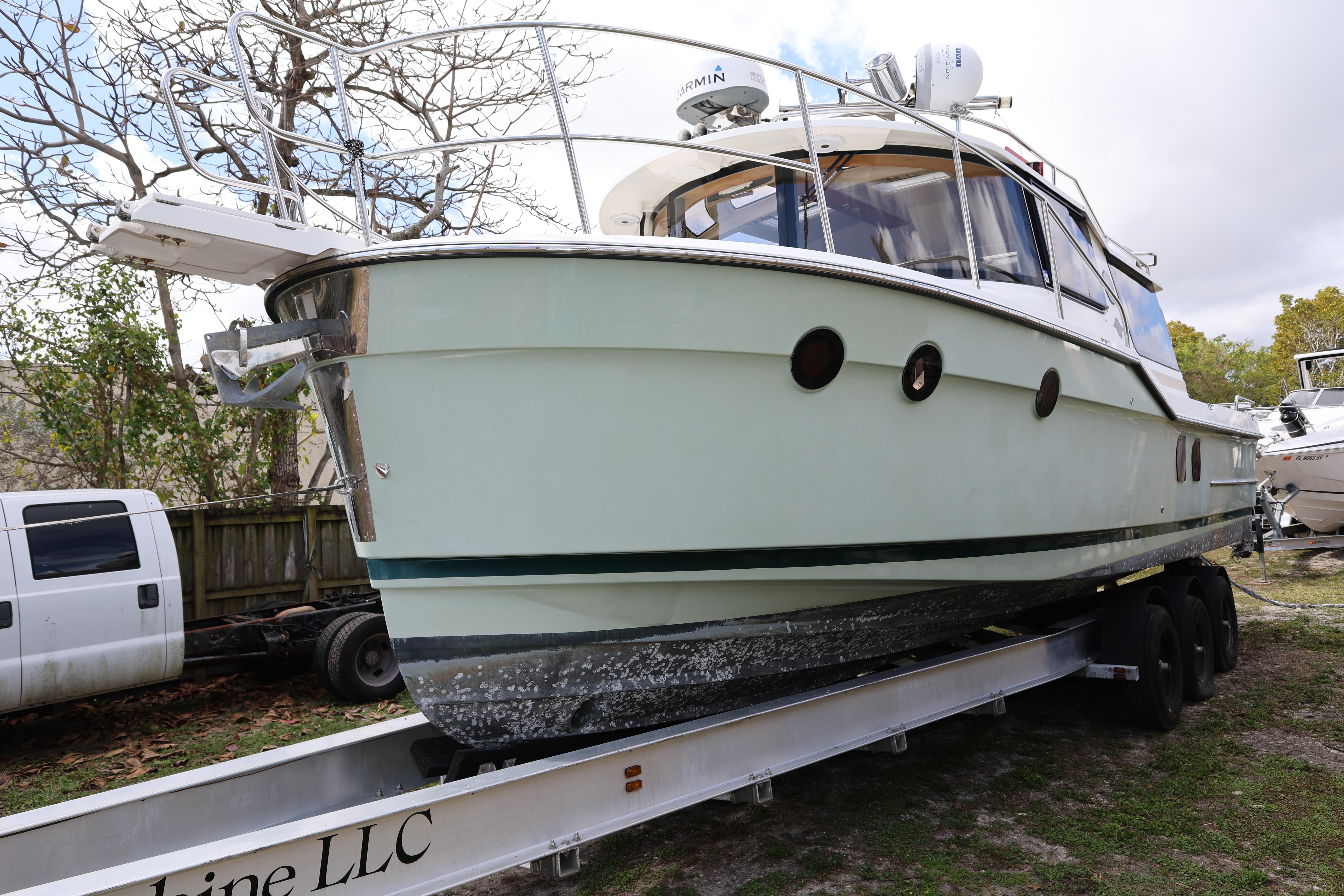 2015 Ranger Tugs R-29 S boat on trailer, parked outdoors.