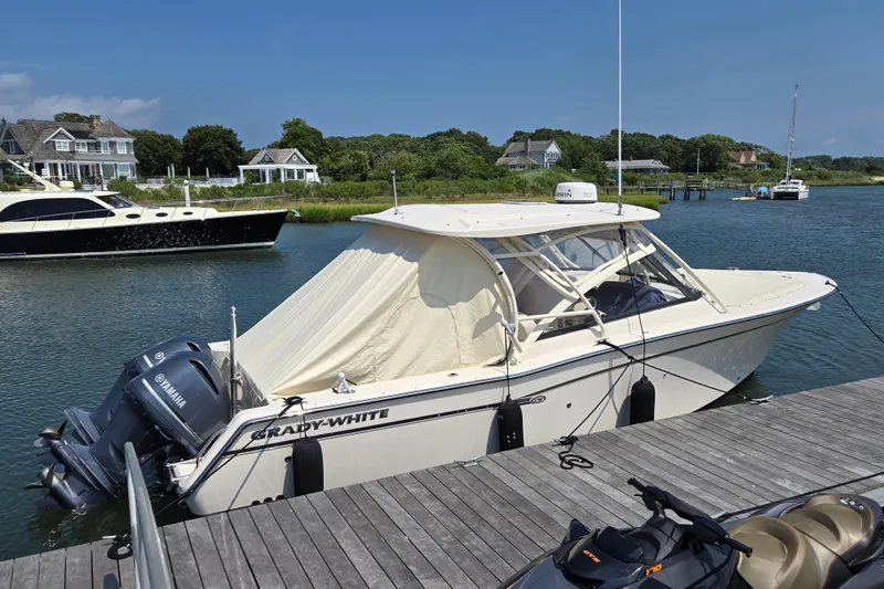  Yacht Photos Pics 2016 Grady-White Freedom 307 boat docked by waterfront homes, featuring Yamaha engines.