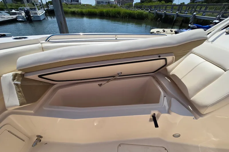 Yacht Photos Pics 2016 Grady-White Freedom 307 boat with open storage compartment by the water.