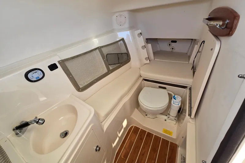  Yacht Photos Pics 2016 Grady-White Freedom 307 boat interior with sink, toilet, and seating area.