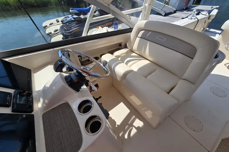  Yacht Photos Pics 2016 Grady-White Freedom 307 boat interior with steering wheel and seating.