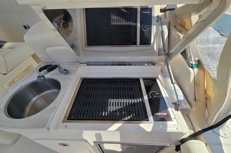  Yacht Photos Pics 2016 Grady-White Freedom 307 boat kitchen with sink and Kenyon grill.