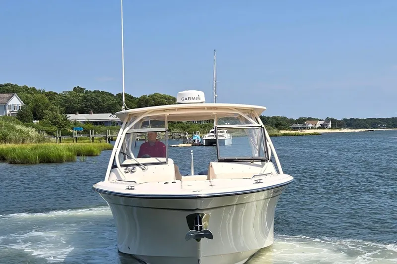  Yacht Photos Pics 2016 Grady-White Freedom 307 boat cruising on a scenic waterway.
