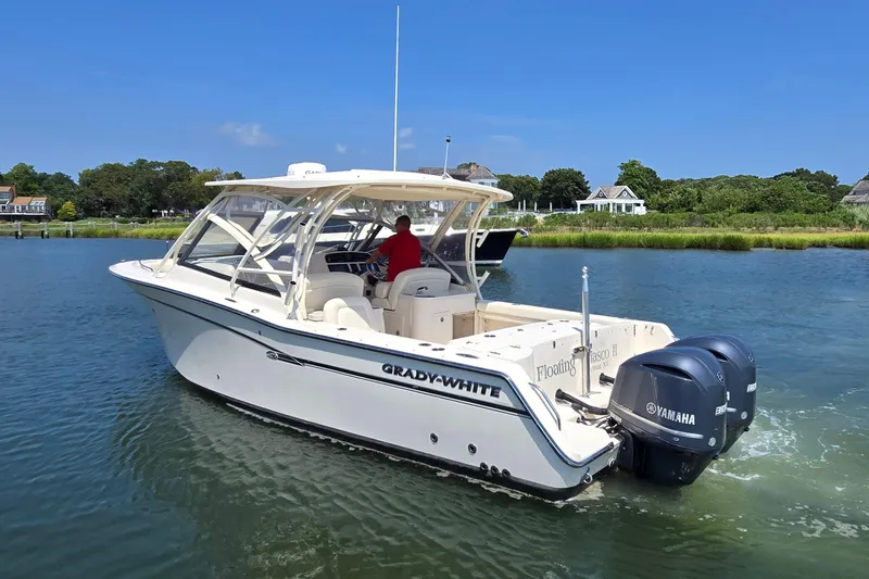 Yacht Photos Pics 2016 Grady-White Freedom 307 boat cruising on a scenic waterway.