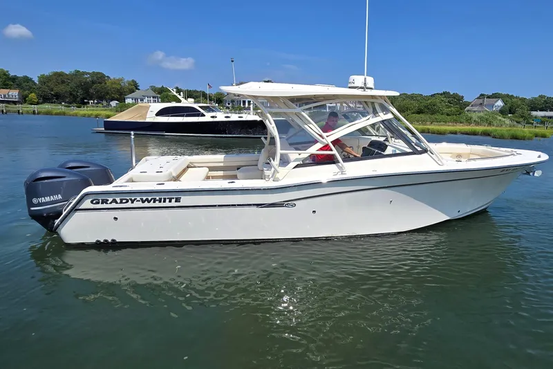  Yacht Photos Pics 2016 Grady-White Freedom 307 boat on calm water, featuring dual Yamaha engines.