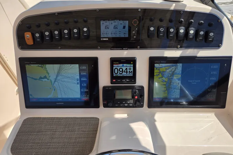  Yacht Photos Pics 2016 Grady-White Freedom 307 boat dashboard with Garmin navigation displays and controls.