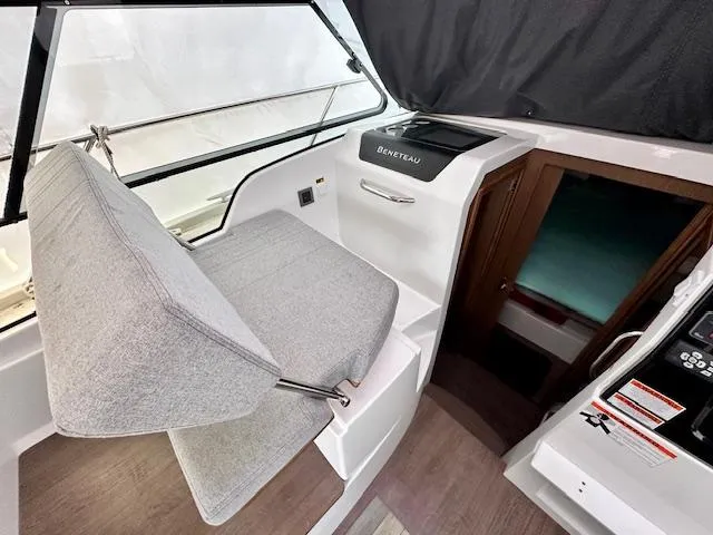  Yacht Photos Pics 2019 Beneteau Antares 27 interior with helm seat and control panel.
