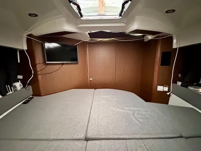  Yacht Photos Pics Interior cabin of 2019 Beneteau Antares 27 with bed and TV.