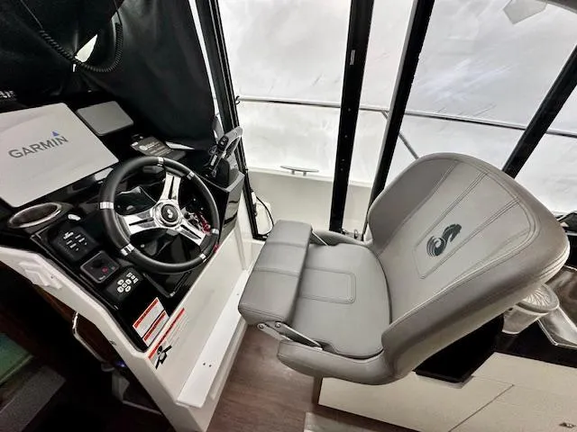  Yacht Photos Pics 2019 Beneteau Antares 27 helm with Garmin navigation, steering wheel, and captain's chair.